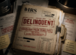 IRS delinquent taxpayer case file with frivolous filing penalties, substitute for return documents, and enforcement priority status under dim desk lighting