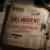 IRS delinquent taxpayer case file with frivolous filing penalties, substitute for return documents, and enforcement priority status under dim desk lighting